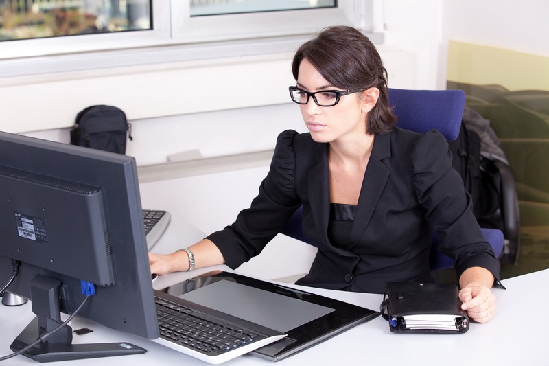 A person working on a laptop to create business systems for online entrepreneurs