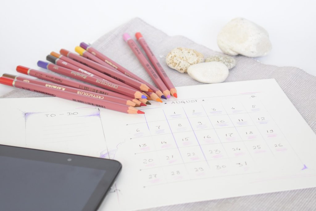 planner and pen, representing the use of traditional tools for productivity and organization