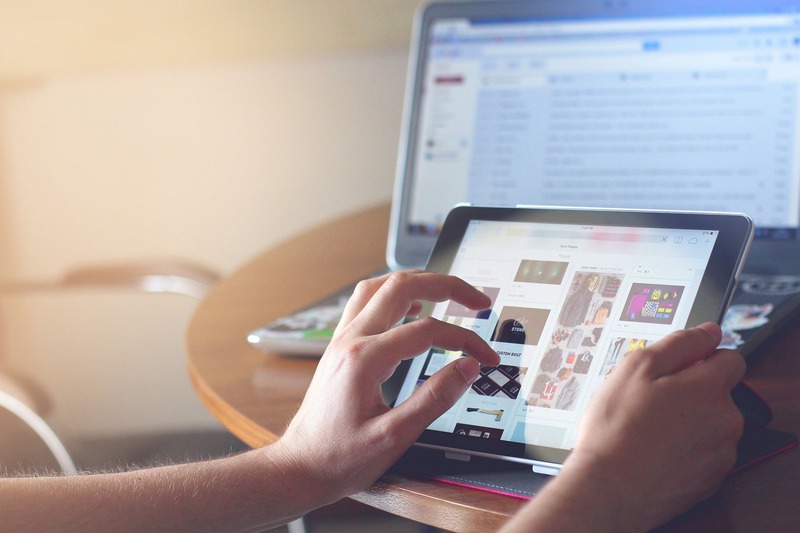 A person using a tablet to manage social media accounts, which entrepreneurs can use to promote their businesses