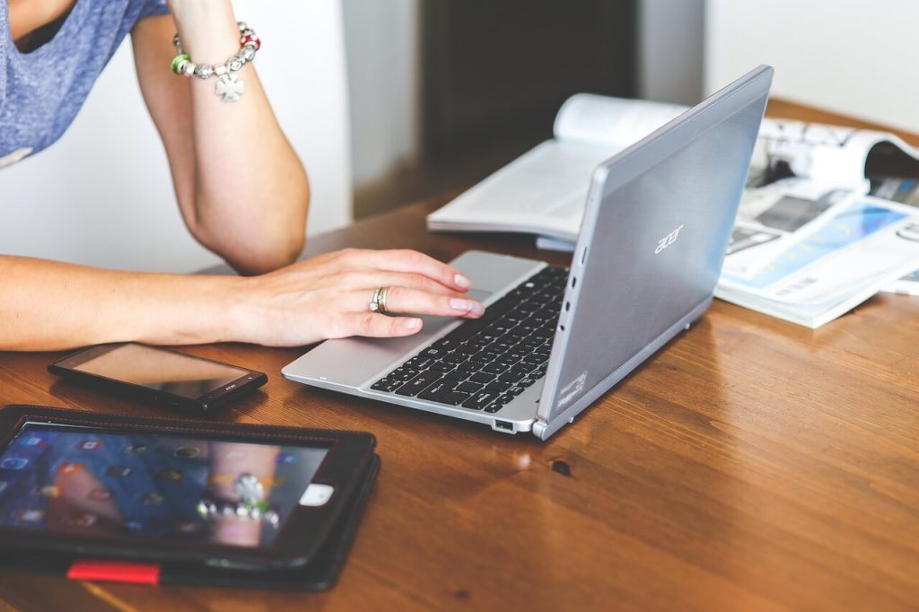 Busy office desk with various technology gadgets and organization tools